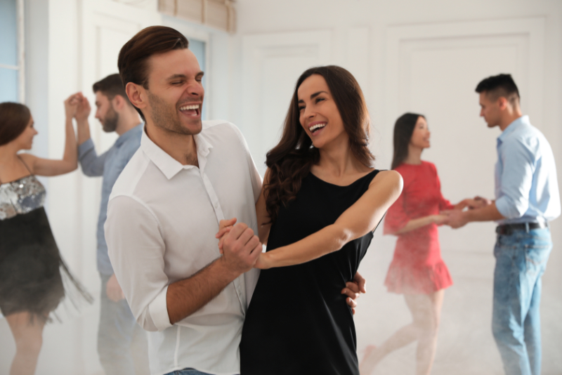 Lovely young couple dancing together at party young couple dancing together
