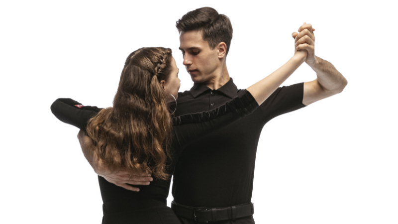 Dynamic portrait of young emotive dancers in black outfits dancing ballroom dance isolated on white background. Concept of art, beauty, music, style. https://wltic.com/a-healthy-beat-how-dancing-can-improve-your-health-and-reduce-stress/